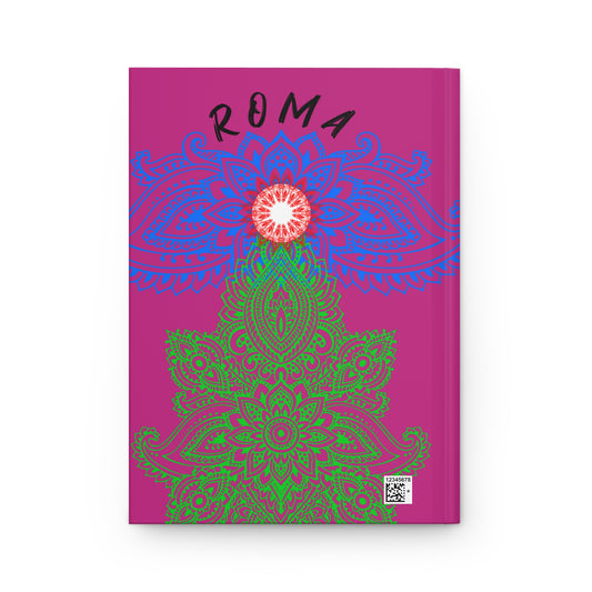 Pink hardcover journal with artistic Roma symbol and soft sand background effect.