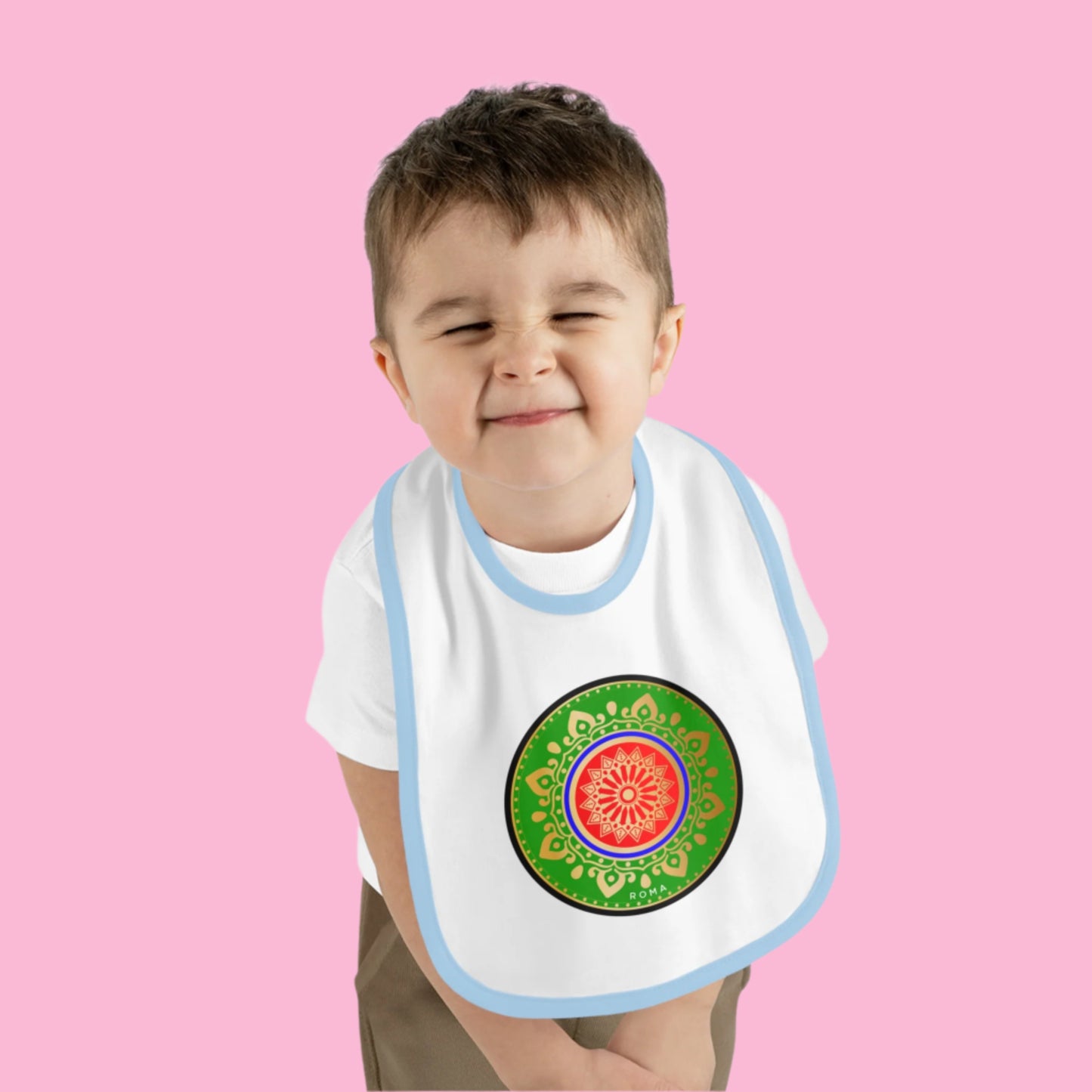 Content baby wearing a bib, flashing a big smile.
