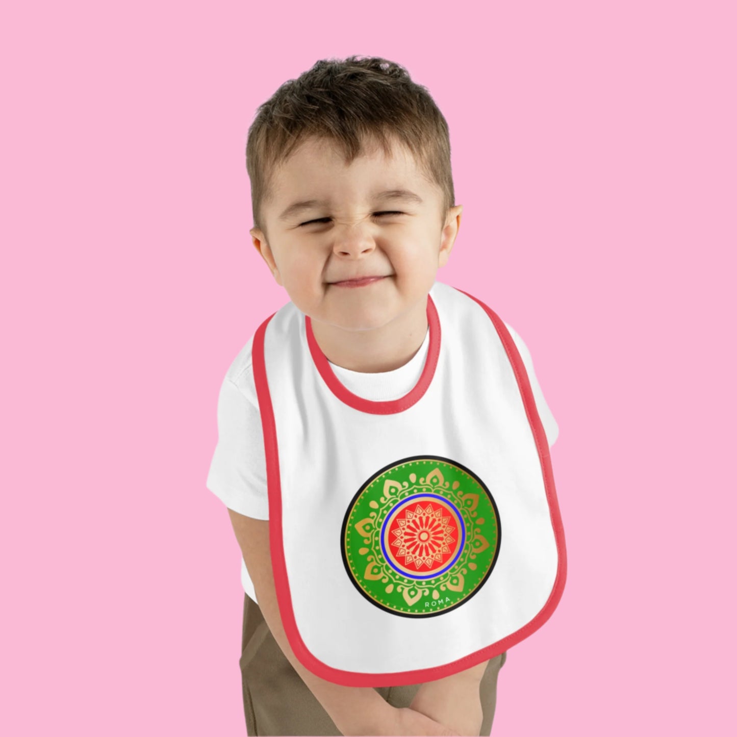 Baby wearing a clean bib and smiling sweetly.