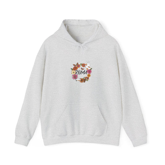 Artistic hoodie design portraying a circular arrangement of seasonal flowers, a dove mid-flight, and classic “ROMA” text enclosed.