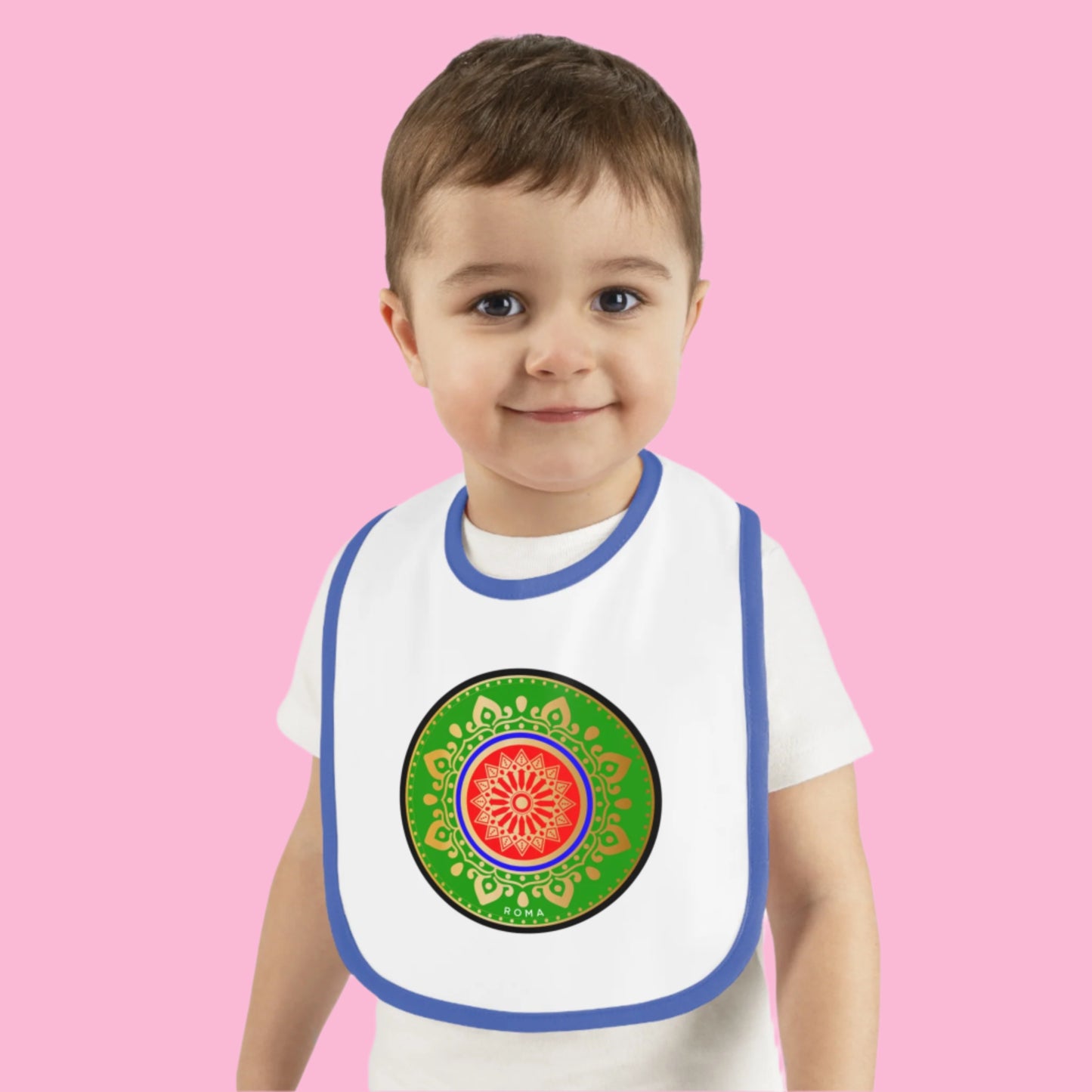 Joyful infant in a bib, grinning with pure delight.