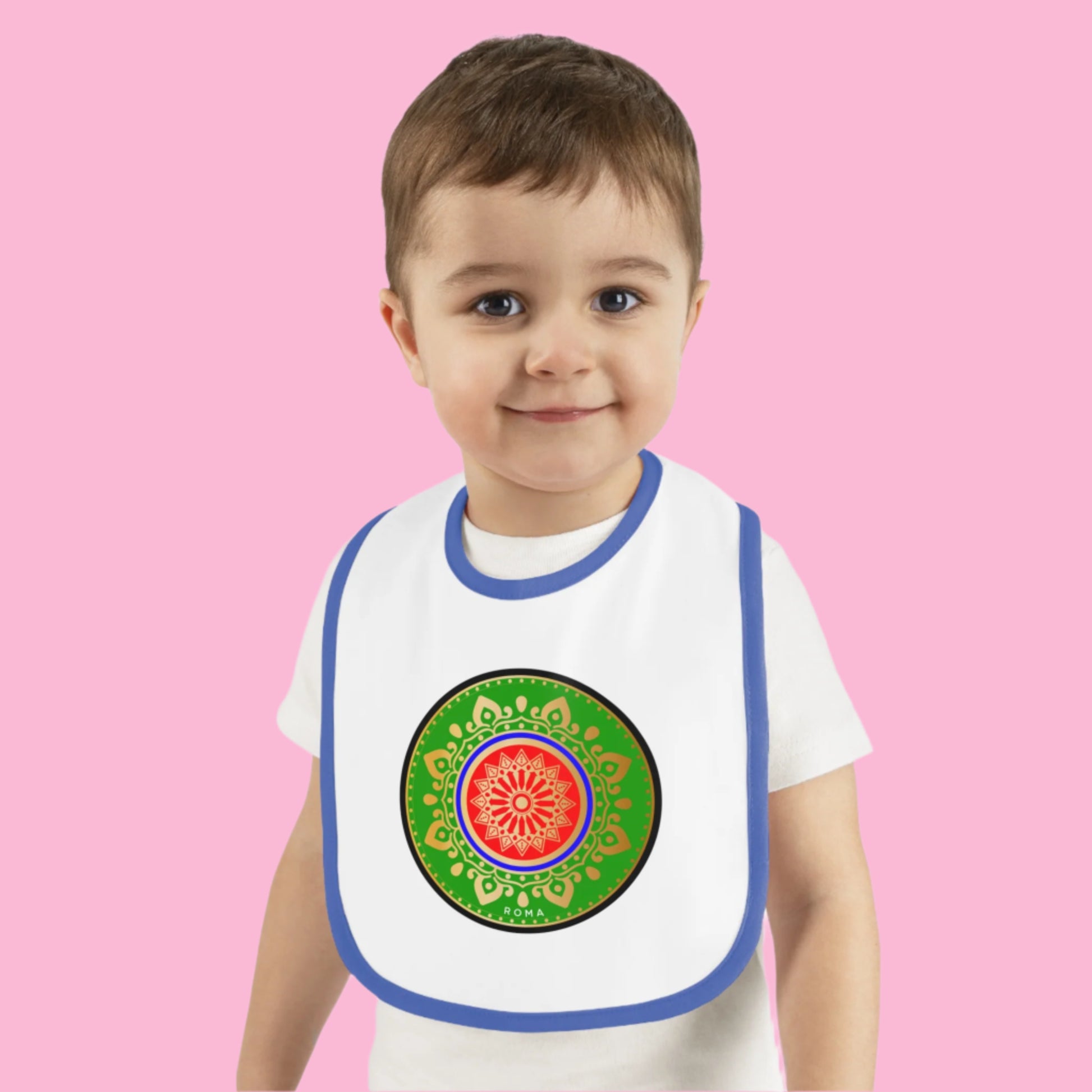 Joyful infant in a bib, grinning with pure delight.