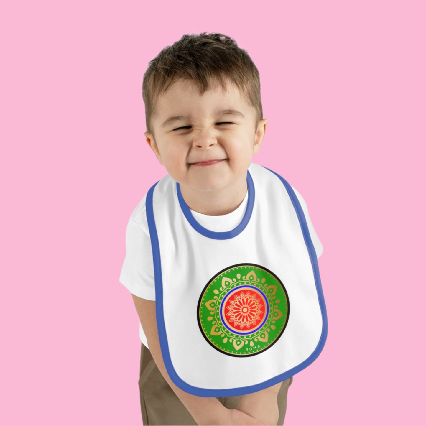 Smiling baby in a bib, ready to eat solid food.