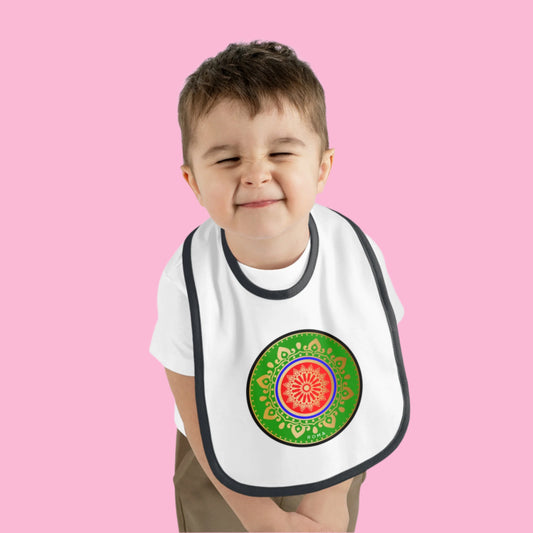 Infant with a bib and a joyful expression.