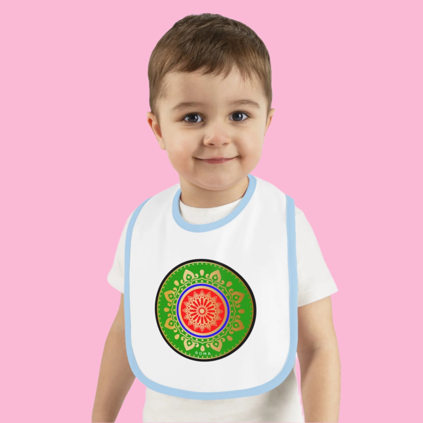 Adorable smiling baby in a bib, sitting upright.