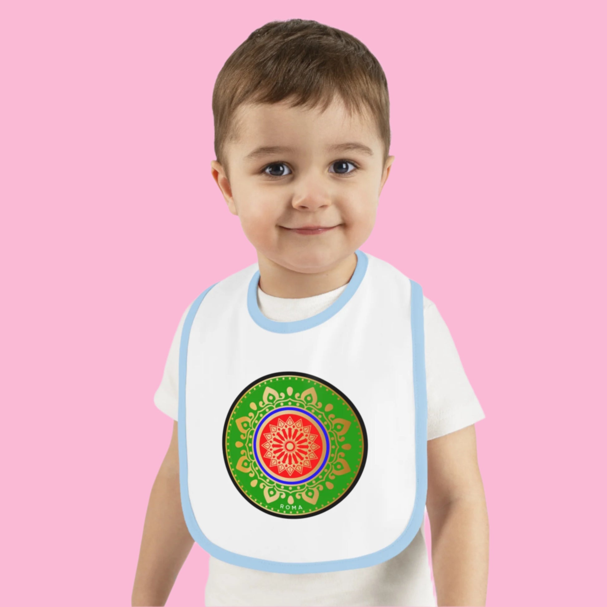 Adorable smiling baby in a bib, sitting upright.