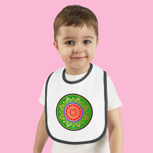 Baby boy wearing a bib from szukar roma designs with black and white 