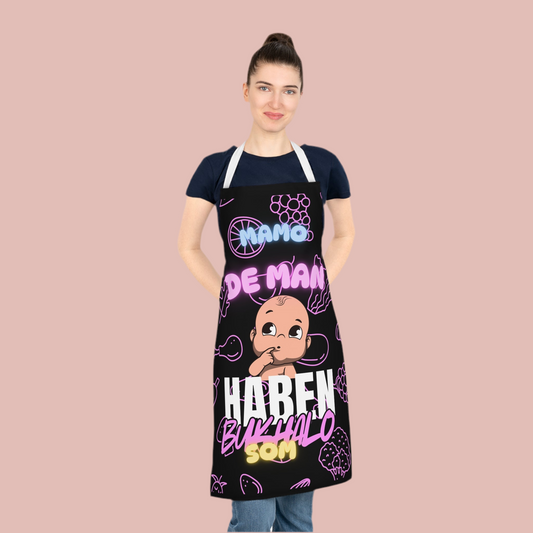 Apron featuring bold  kitchen Armor text with a detailed baby graphic and MAMO text from Szukar Roma.
