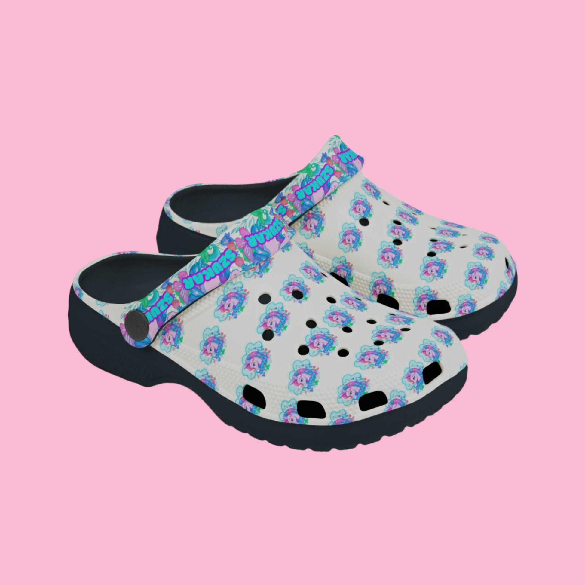 Pair of colorful Crocs decorated with playful unicorn graphics and rainbows.

