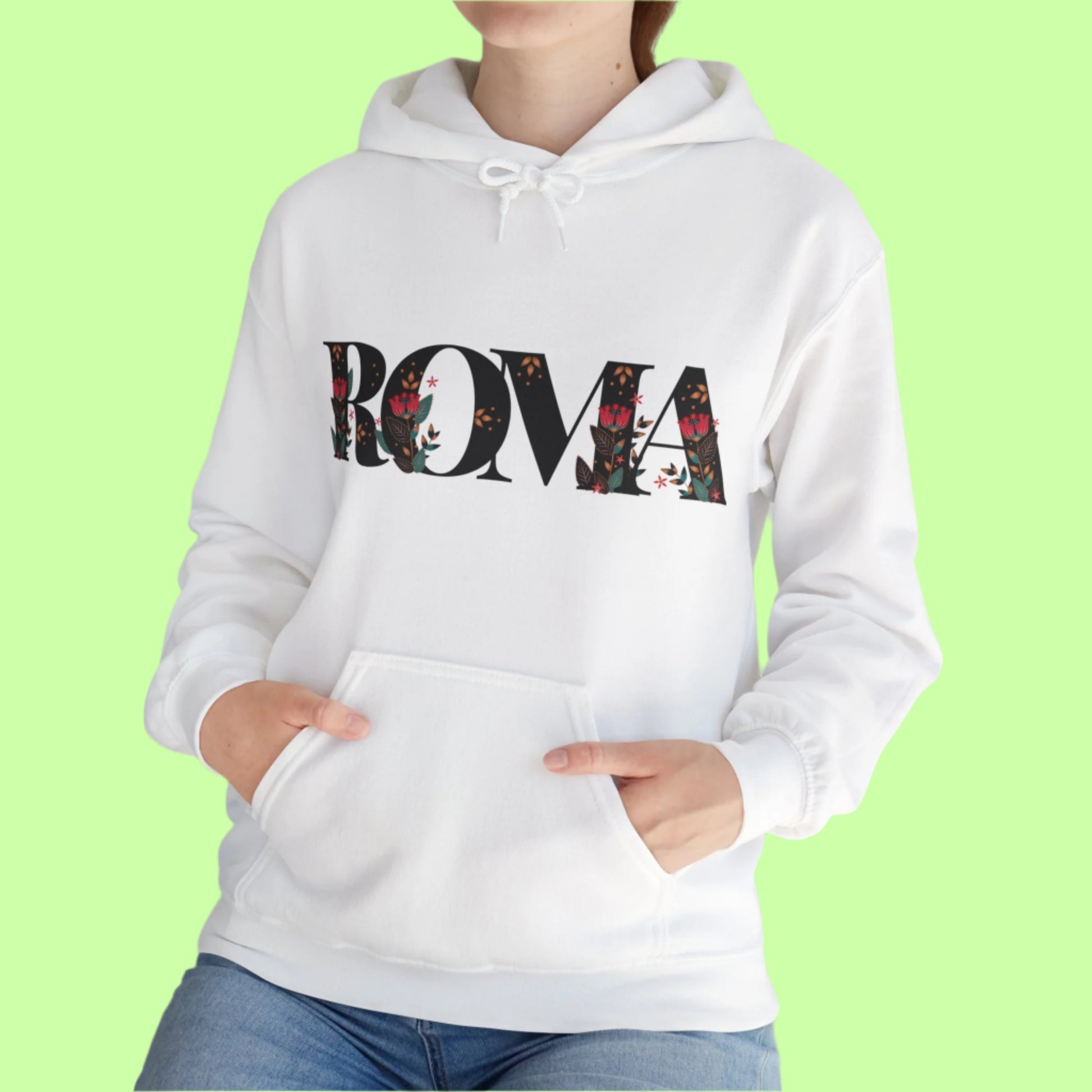 Floral-infused ROMA text design on hoodie, mixing streetwear and softness.

